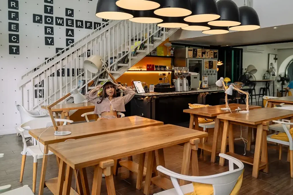 Shared workspace with desks and task lamps at a Blu Monkey hotel