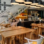 Shared workspace with desks and task lamps at a Blu Monkey hotel