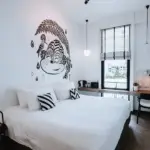 Guest room with rain-inspired wall art at Blu Monkey Hub & Hotel Ranong